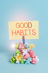 Word writing text Good Habits. Business photo showcasing behaviour that is beneficial to one s is physical or mental health Reminder pile colored crumpled paper clothespin reminder blue background
