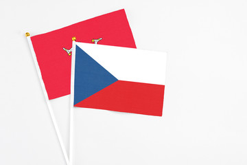 Czech Republic and Isle Of Man stick flags on white background. High quality fabric, miniature national flag. Peaceful global concept.White floor for copy space.