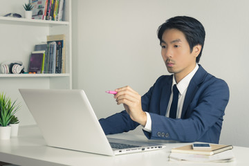 Asian Financial Advisor or Asian Consulting Businessman Suggest Customer Via Internet in Vintage Tone