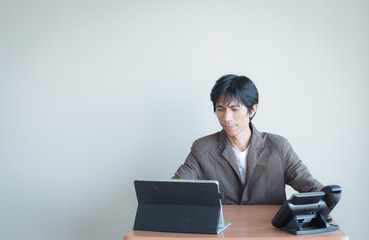 Aฺsian business man in room and action stance with copy space.