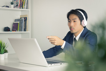 Asian Man Call Center Seriously Answer Customer Questions in Vintage Tone