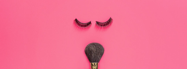 Makeup brush and False Eyelashes Lying On Pink Background. Beauty And Makeup Concept. Flatlay, Mock...