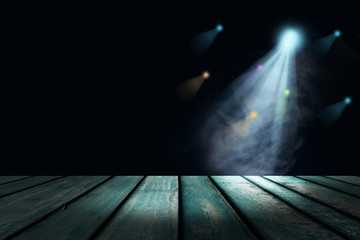 cyan teal lighting and smoke on stage with floor wood