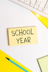 Text sign showing School Year. Business photo showcasing the annual period of sessions of an educational institution Flat lay above table with pc keyboard and copy space paper for text messages