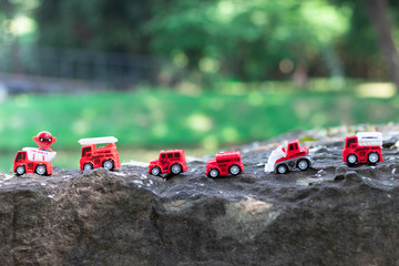 Red toy cars with green background macro