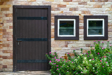 Fototapeta na wymiar brown wooden door and window with brick wall background
