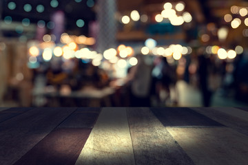 top desk with blur restaurant background,Wooden table and blurred bokeh of night street background