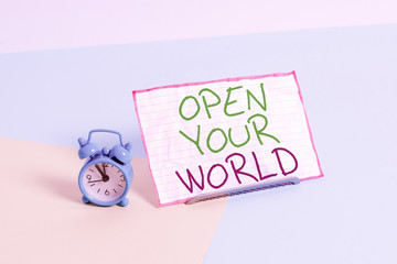 Handwriting text writing Open Your World. Conceptual photo Broaden your mind and mentality from any negativity Mini size alarm clock beside a Paper sheet placed tilted on pastel backdrop