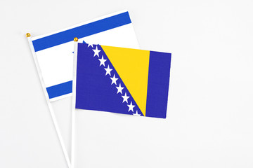 Bosnia Herzegovina and Israel stick flags on white background. High quality fabric, miniature...