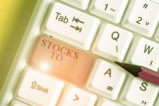 Conceptual hand writing showing Stocks To Watch. Concept meaning being heavy broker and watch every increase decrease White pc keyboard with note paper above the white background