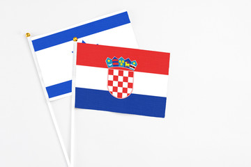 Croatia and Israel stick flags on white background. High quality fabric, miniature national flag. Peaceful global concept.White floor for copy space.