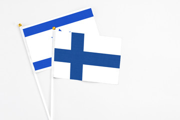 Finland and Israel stick flags on white background. High quality fabric, miniature national flag. Peaceful global concept.White floor for copy space.