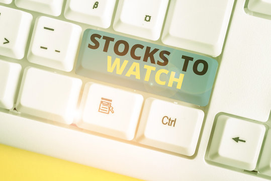 Text sign showing Stocks To Watch. Business photo text being heavy broker and watch every increase decrease White pc keyboard with empty note paper above white background key copy space