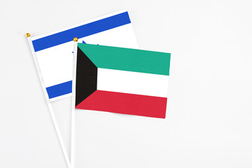 Kuwait and Israel stick flags on white background. High quality fabric, miniature national flag. Peaceful global concept.White floor for copy space.