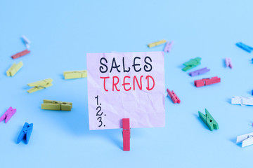 Handwriting text Sales Trend. Conceptual photo Composite data of a company s is annual sales and employment Colored clothespin rectangle square shaped paper light blue background