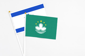 Macao and Israel stick flags on white background. High quality fabric, miniature national flag. Peaceful global concept.White floor for copy space.