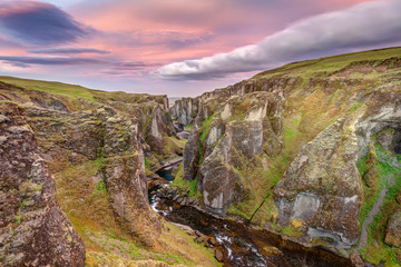 The very scenic Fjadrargljufur Canyon at Sunrise in the South-East of Iceland. Shaped by Glacier melt water over millions of years.