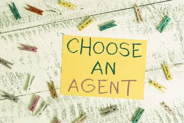 Conceptual hand writing showing Choose An Agent. Concept meaning Choose someone who chooses decisions on behalf of you Colored clothespin rectangle shaped paper blue background