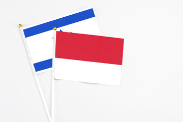 Monaco and Israel stick flags on white background. High quality fabric, miniature national flag. Peaceful global concept.White floor for copy space.