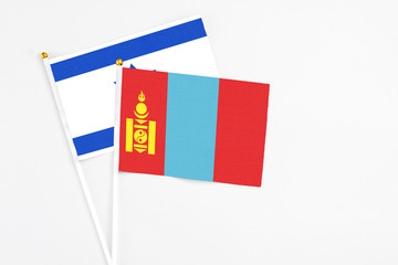Mongolia and Israel stick flags on white background. High quality fabric, miniature national flag. Peaceful global concept.White floor for copy space.