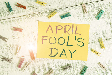 Conceptual hand writing showing April Fool S Day. Concept meaning Practical jokes humor pranks Celebration funny foolish Colored clothespin rectangle shaped paper blue background