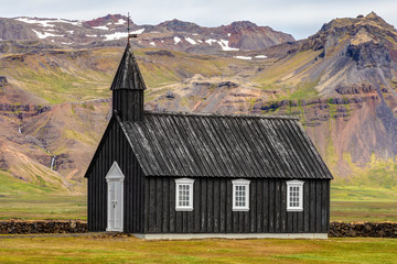 Fototapeta na wymiar Black Church, On the south coast of Snæfellsnes peninsula In the West of Iceland with colorful mountains