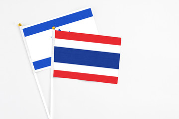 Thailand and Israel stick flags on white background. High quality fabric, miniature national flag. Peaceful global concept.White floor for copy space.