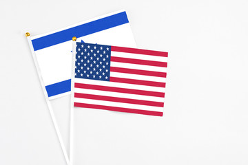 United States and Israel stick flags on white background. High quality fabric, miniature national flag. Peaceful global concept.White floor for copy space.