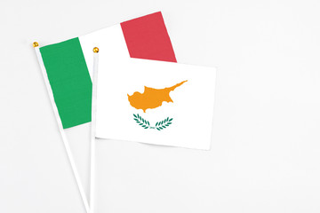 Cyprus and Italy stick flags on white background. High quality fabric, miniature national flag. Peaceful global concept.White floor for copy space.