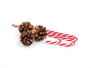 Christmas decorations candy cane and pine cone isolated on white background..