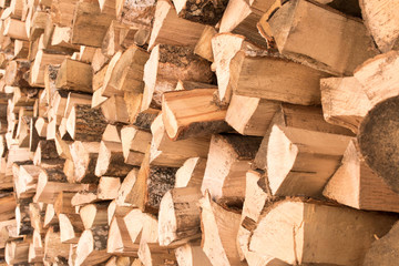 The background texture of a large pile of wood. Close up. Selective focus.
