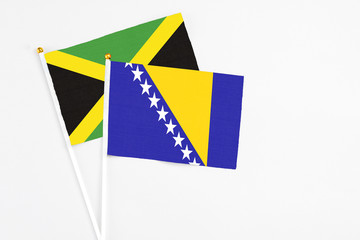 Bosnia Herzegovina and Jamaica stick flags on white background. High quality fabric, miniature...