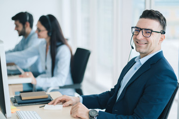 Fototapeta premium Service Team Concept. Operator or Contact Center Sale in Office, Information People Call Center, Quality Professional Team Sales Support Office. Environment Workplace Representative Company. 