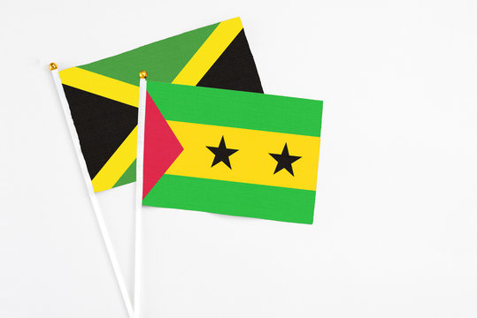 Sao Tome And Principe and Jamaica stick flags on white background. High quality fabric, miniature national flag. Peaceful global concept.White floor for copy space.