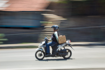 Fototapeta na wymiar Motion Blurred panning photo of Unidentified name people riding motorcycle