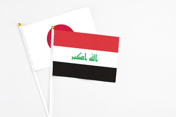 Iraq and Japan stick flags on white background. High quality fabric, miniature national flag....