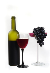 Glass of wine, a bottle and grapes on a white background. Isolated on white.
