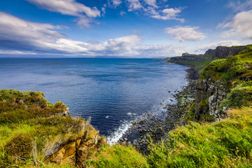 Fototapeta na wymiar Waves breaking on coastal cliffs of Scotland.