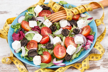 Centimeter and greek salad with feta cheese and vegetables. Healthy lifestyles, food and slimming