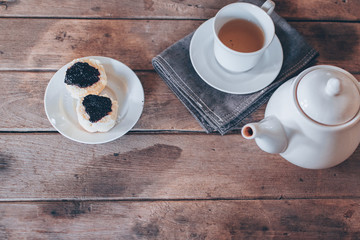 cup of tea and scone on wooden table