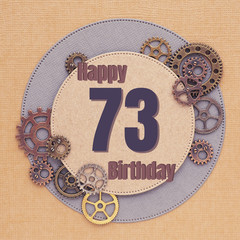 Greeting card for men with gears of different sizes and colors with circles and the inscription "Happy Birthday 73"..