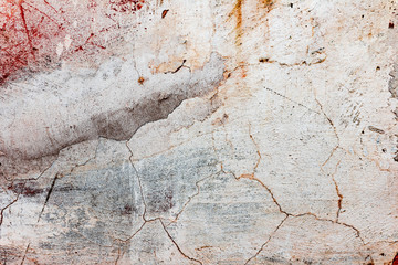 Texture of a concrete wall with cracks and scratches which can be used as a background