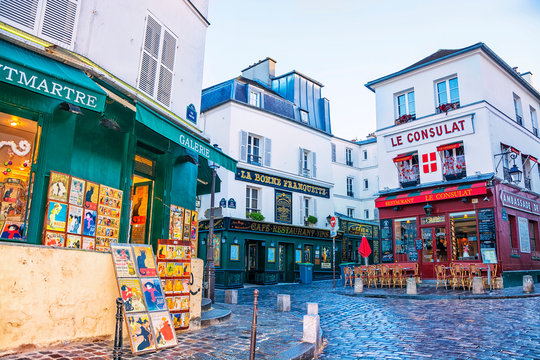 PARIS, FRANCE - DECEMBER 11,2016: Typical French street in Montmartre district with small houses are located cafes, restaurants and art galleries.