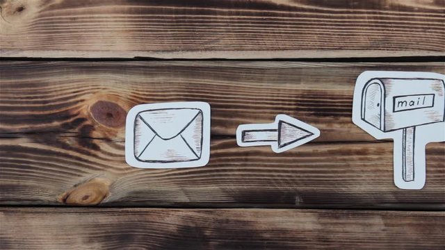 Paper drawing sketches with mail-themed letters on wooden