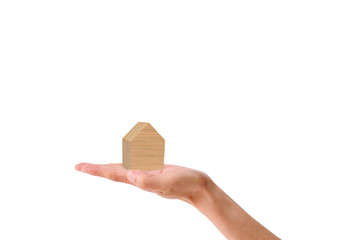 Real Estate Concept : Hand holding wooden house model isolated on white background.