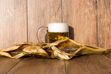 Oktoberfest holiday concept. Smoked fish and a glass of beer. Cold smoked pike perch on a dark rustic background.