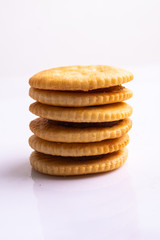 stack Round crackers with salt on white background