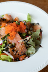 Salmon Salad with dressing salad with greenoak, Olive, tomatoes. Home made food. Concept for a tasty and healthy meal.  Top view. Close up.