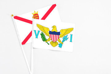 United States Virgin Islands and Jersey stick flags on white background. High quality fabric, miniature national flag. Peaceful global concept.White floor for copy space.