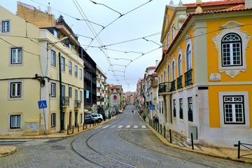 Naklejka na ściany i meble Narrow street in the Lisbon city Portugal 30.Oct.2019 It is famous for its beautiful labyrinthine streets